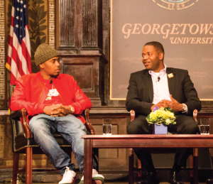 DANIEL SMITH/THE HOYA Rapper Nas, left, discusses the legitimacy of hip-hop in academia with professor James Braxton Peterson on Thursday in Gaston Hall. 