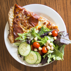 Instead of having three slices, try  having one to two slices of pizza with a salad on the side.