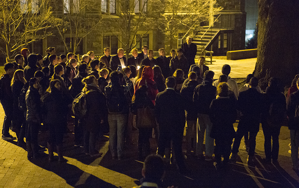 ALEXANDER BROWN/THE HOYA Around 100 students joined to mourn the deaths of three Muslim students in a shooting at UNC Chapel Hill.