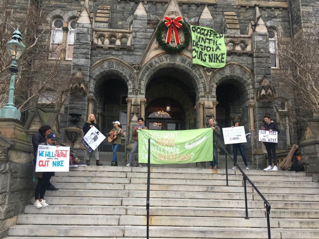 JEANINE SANTUCCI/THE HOYA Members of worker's rights advocacy group Georgetown Solidarity Committee are demonstrating against Georgetown's licensing contract with Nike inside and outside the University President John J. DeGioia's suite of offices and outside Healy Hall. 