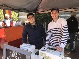 WILLIAM ZHU/THE HOYA Joseph Hwang (MSB ’19), left, and Chas Newman (MSB ’19) launched their french fries company at the year’s first farmers’ market.